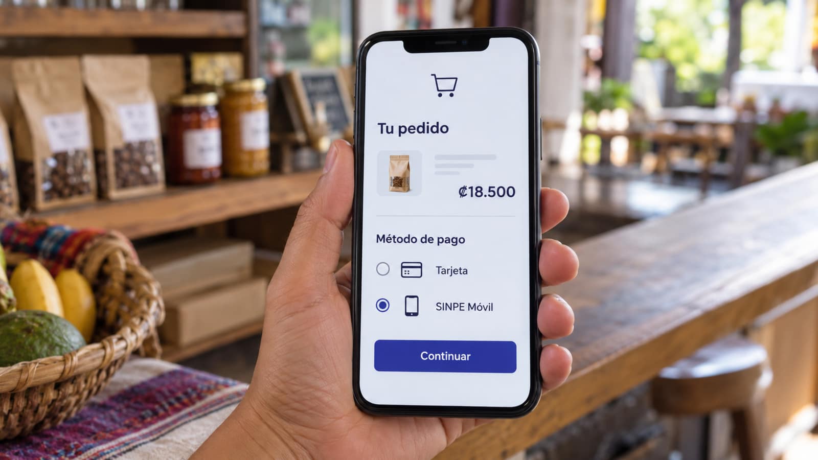 Photo of a phone showing a Costa Rican online store with the shopping cart and the option to pay with SINPE Móvil
